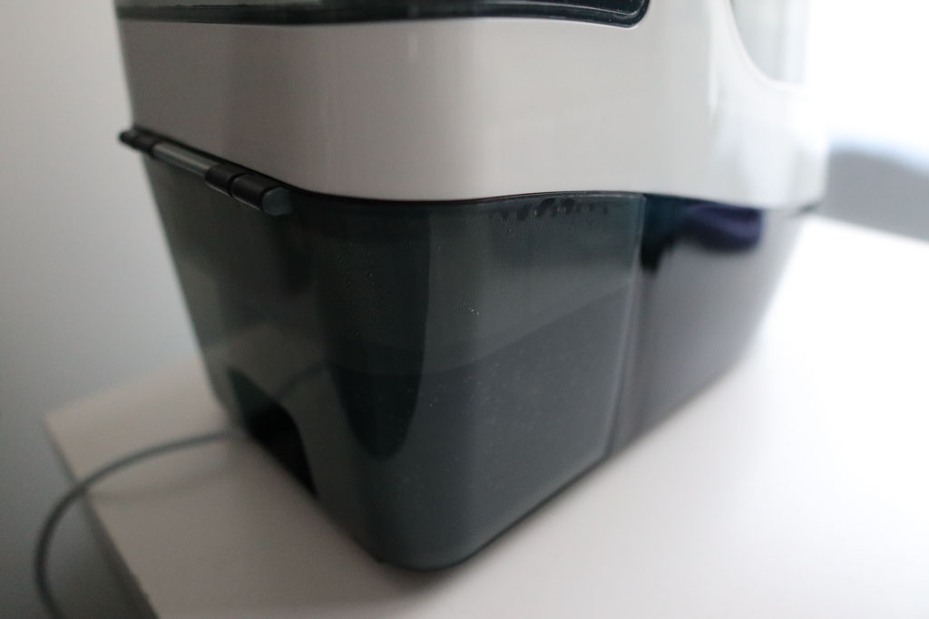 Rear view of the Baby Brezza Bottle Washer Pro showing its dirty water collection tank that must be emptied after each wash cycle