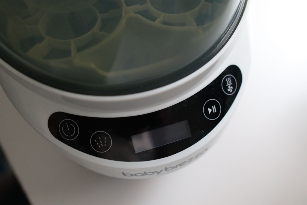 A close-up view of the four buttons used to operate the Baby Brezza Bottle Washer Pro.