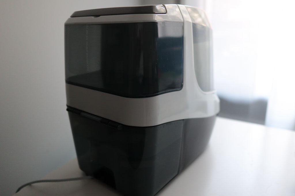 The Baby Brezza Bottle Washer Pro placed on a desk in my nursery, as seen from the back.