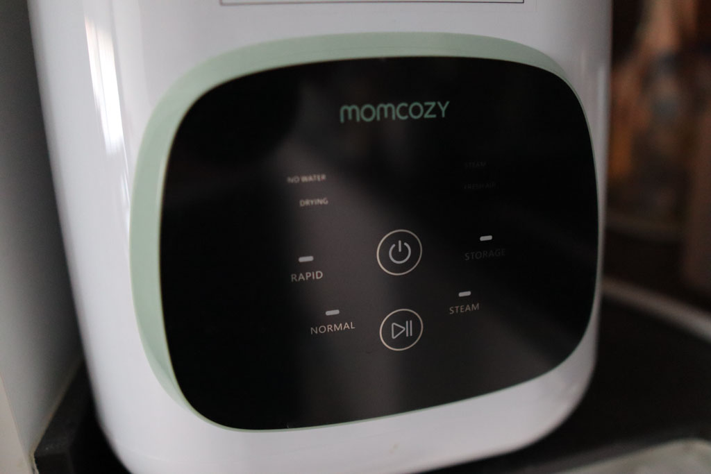 A close-up photo of the Momcozy KleanPal Pro's touchscreen.