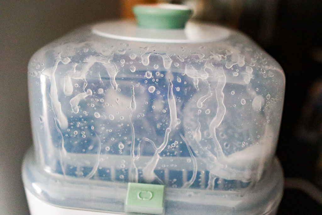 A photo of a nipple shield container that has moved from its original place to the edge of the top rack mid-wash cycle.