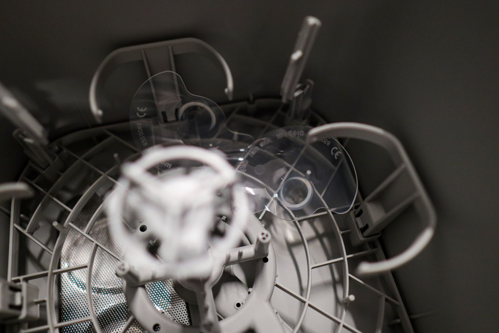 Nipple shields flipped upside down inside the Momcozy KleanPal Pro after a wash cycle due to strong water pressure