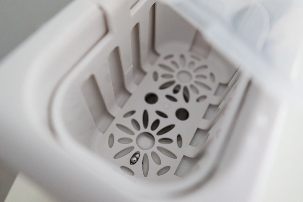 Inside the Grownsy 8-in-1 Bottle Warmer showing the water temperature sensor and heating element with the anti-scald basket.