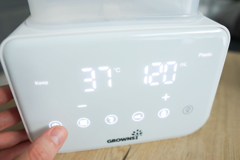 The second-generation Grownsy 8-in-1 Bottle Warmer's LCD screen displaying temperature, time, and cycle mode with icon-based controls.